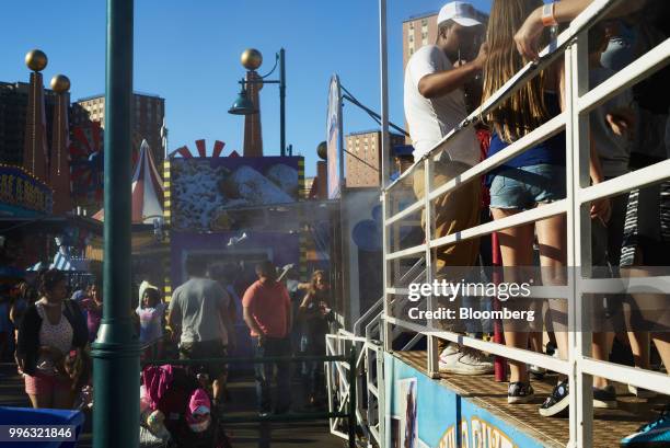 People stand on lines for amusement rides at Luna Park in Coney Island in the Brooklyn Borough of New York, U.S., on Saturday, July 7, 2018....