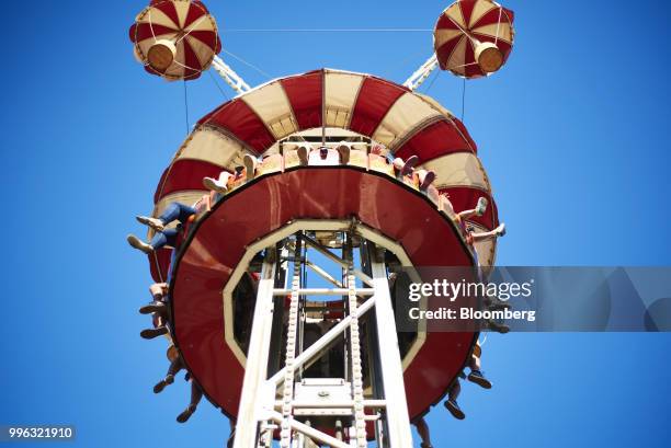 People sit on an amusement ride at Luna Park in Coney Island in the Brooklyn Borough of New York, U.S., on Saturday, July 7, 2018. Bloomberg is...