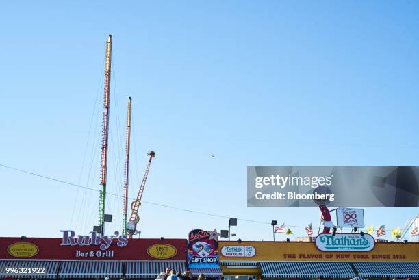 Ruby's Bar & Grill and Nathan's Famous Inc. Restaurants stand on the Coney Island boardwalk in the Brooklyn Borough of New York, U.S., on Saturday,...