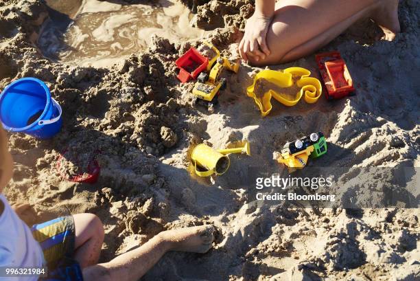 Children play with toys on Coney Island beach in the Brooklyn Borough of New York, U.S., on Saturday, July 7, 2018. Bloomberg is scheduled to release...