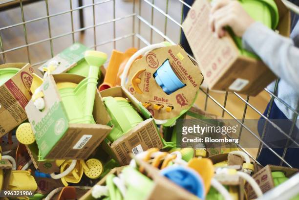 Customer views Green Toys Inc. Beach toys on display for sale at a store on the Coney Island boardwalk in the Brooklyn Borough of New York, U.S., on...