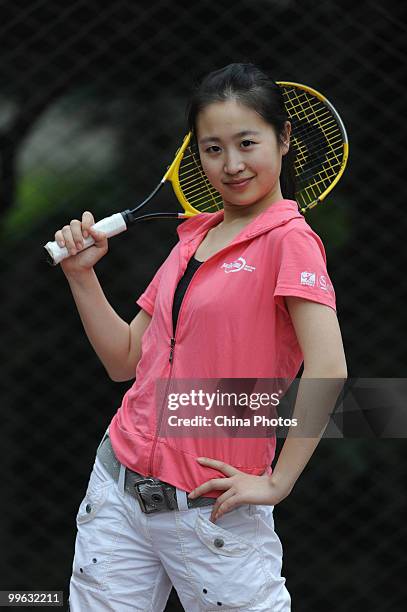 Huai Xue, 19-year-old student of the Beijing Normal University and volunteer of the China Open, poses for pictures during the training session of...