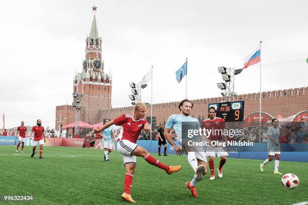 Marina Fedorova and Diego Forlan compete during the Legends Football Match in "The park of Soccer and rest" at Red Square on July 11, 2018 in Moscow,...