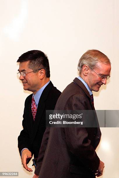 Commerce Secretary Gary Locke, left, walks past Stephen M. Young, counsel-general of the United States, while going on state to speak at the Clean...