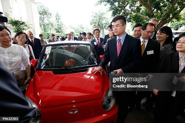 Commerce Secretary Gary Locke, in red tie, inspects a EuAuto Technology Ltd. MyCar electric vehicle in Hong Kong, China, on Monday, May 17, 2010....