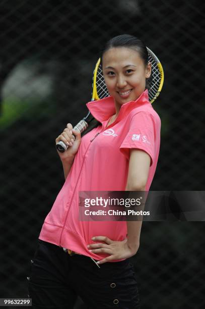 Fu Zheying, 19-year-old student of the Beijing Normal University and volunteer of the China Open, poses for pictures during the training session of...