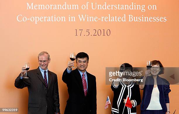 Officials toast after a signing ceremony of a memorandum of understanding on co-operation in wine related businesses in Hong Kong, China, on Monday,...