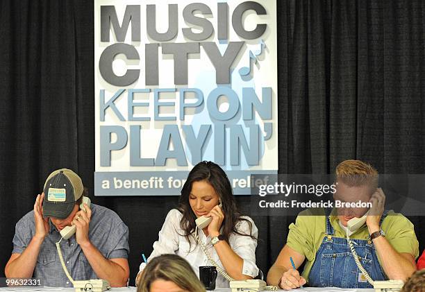 Country singers Rodney Atkins, Rory Feek, and Joey Martin work the phone bank during the "Music City Keep on Playin'" benefit concert at the...