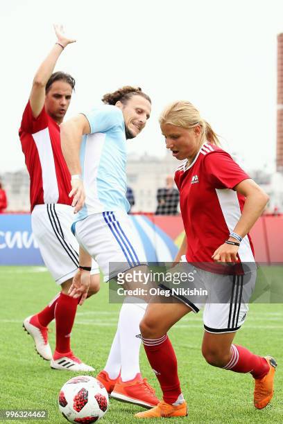 Diego Forlan competes for the ball with Marina Fedorova during the Legends Football Match in "The park of Soccer and rest" at Red Square on July 11,...