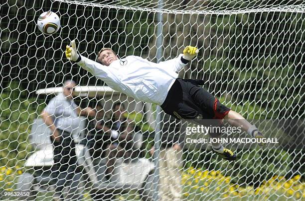 Germany's goalkeeper Manuel Neuer goes for a save during a training session at the Verdura Golf and Spa resort, near Sciacca May 16, 2010. The German...