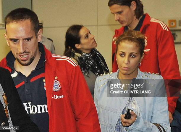 Bayern Munich's French midfielder Franck Ribery arrives with his wife Wahiba and teammates at the airport in the southern German city of Munich after...