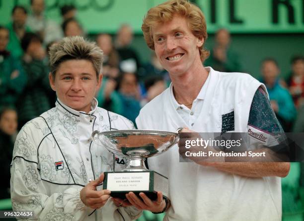 Larisa Neiland of Latvia and Mark Woodforde of Australia pose with the trophy after defeating Jill Hetherington of Canada and John-Laffnie de Jager...