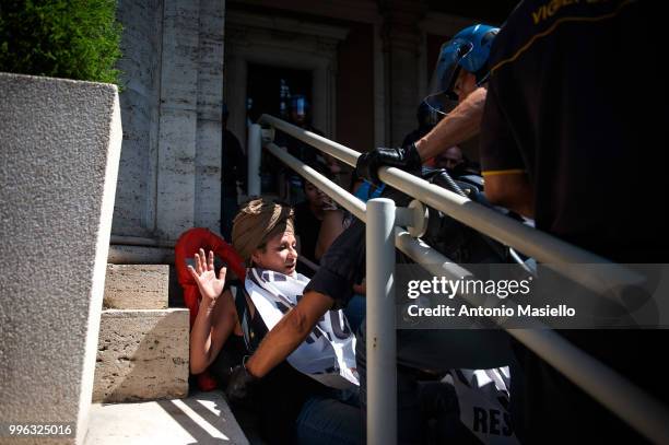 Italian Police remove the protesters wearing life jackets from the Ministry of Transport during a protest against the Italian immigration policy, on...