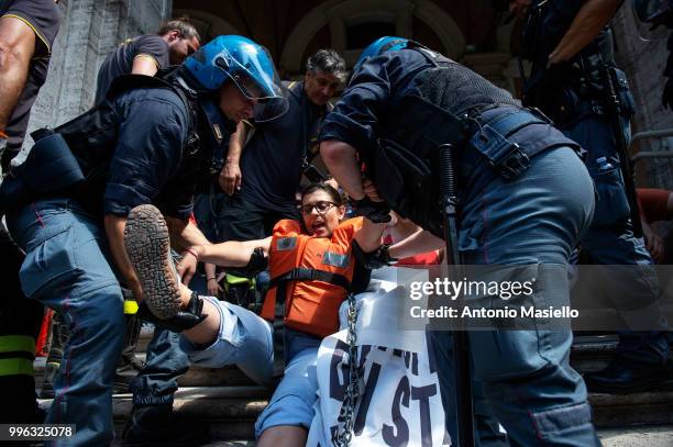 Italian Police remove the protesters wearing life jackets from the Ministry of Transport during a protest against the Italian immigration policy, on...