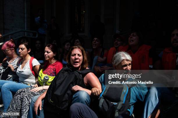 Dozens of protesters wearing life jackets chained themselves outside the Ministry of Transport during a protest against the Italian immigration...