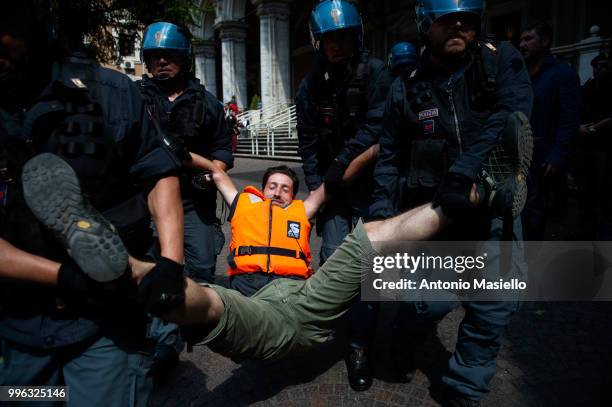 Italian Police remove the protesters wearing life jackets from the Ministry of Transport during a protest against the Italian immigration policy, on...