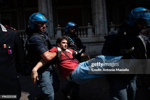 Italian Police remove the protesters wearing life jackets from the Ministry of Transport during a protest against the Italian immigration policy, on...