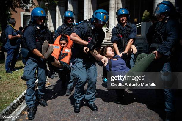 Italian Police remove the protesters wearing life jackets from the Ministry of Transport during a protest against the Italian immigration policy, on...