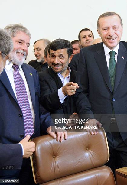 Brazilian President Luiz Inacio Lula da Silva, and Turkish Prime Minister Recep Tayyip Erdogan smile as Iranian President Mahmoud Ahmadinejad talks...