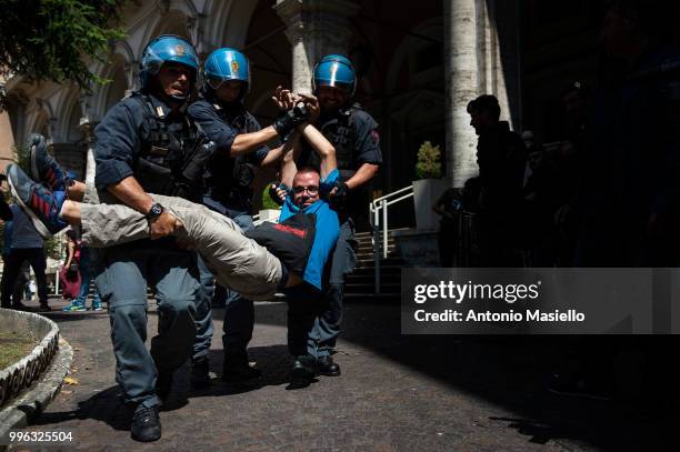 Italian Police remove the protesters wearing life jackets from the Ministry of Transport during a protest against the Italian immigration policy, on...