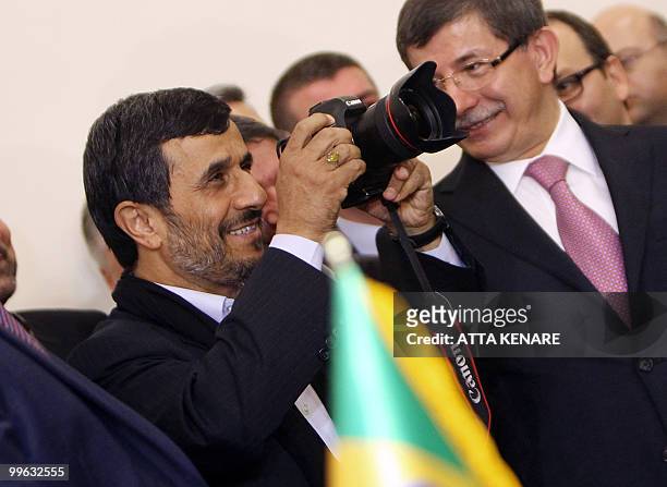 Iranian counterpart President Mahmoud Ahmadinejad takes a picture of Turkish Prime Minister Recep Tayyip Erdogan while standing next to Turkey's...