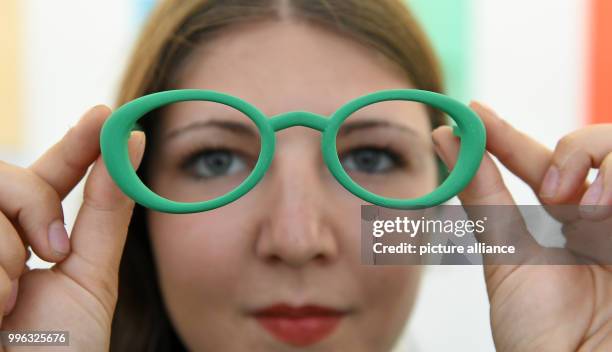 July 2018, Germany, Halle/Saale: The student Sophia Reissenweber shows her work 'Resus' with spectacle frames made of recycled materials during a...