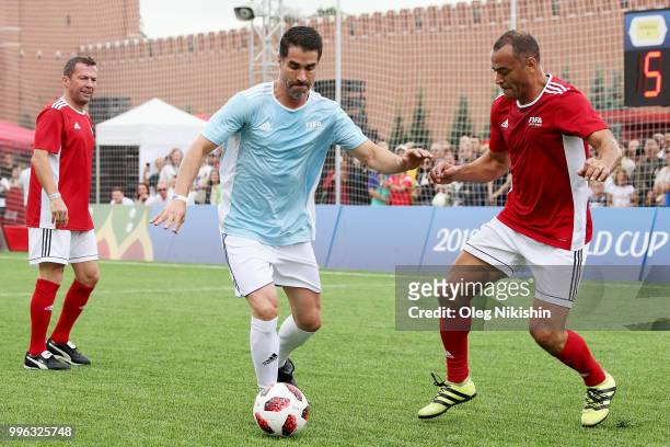 Juan Pablo Angel competes with Cafu during the Legends Football Match in "The park of Soccer and rest" at Red Square on July 11, 2018 in Moscow,...
