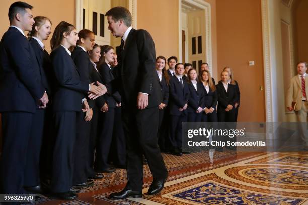 Judge Brett Kavanaugh shakes hands with members of the Senate Page program after posing for photographs with them at the U.S. Capitol July 11, 2018...