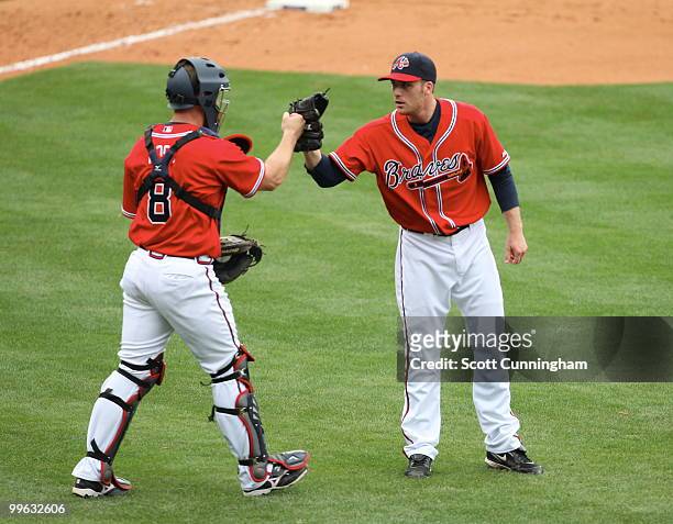 Eric O'Flaherty and David Ross of the Atlanta Braves celebrate after the game against the Arizona Diamondbacks at Turner Field on May 16 2010 in...