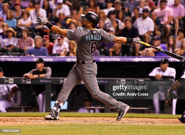 Arizona Diamondbacks right fielder David Peralta hits a three-run home run off Colorado Rockies relief pitcher Jake McGee in the 7th inning at Coors...