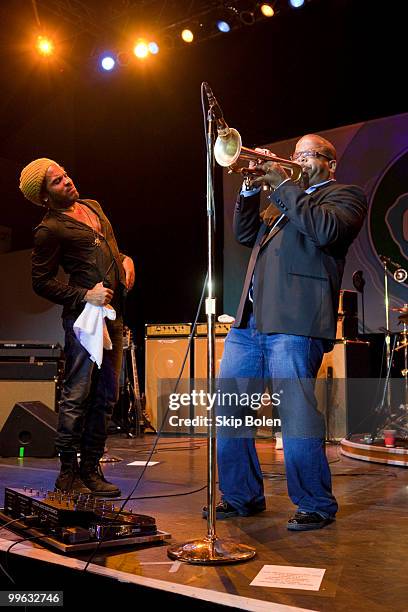 Musician Lenny Kravitz looks on as New Orleans jazz trumpeter Terence Blanchard performs at the GULF AID benefit concert at Mardi Gras World River...