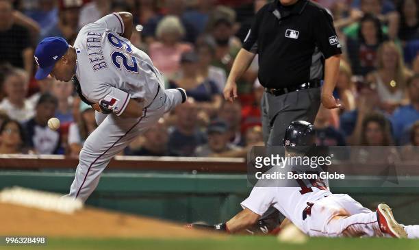Boston Red Sox player Andrew Benintendi is safe at third base during a bottom of the seventh inning double steal. Rangers third baseman Adrian Beltre...