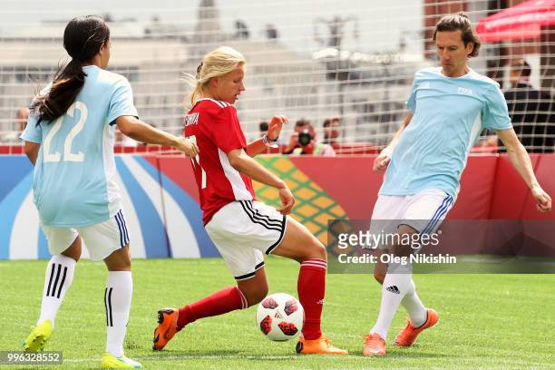 Marina Fedorova competes for the ball with Alexey Smertin during the Legends Football Match in "The park of Soccer and rest" at Red Square on July...