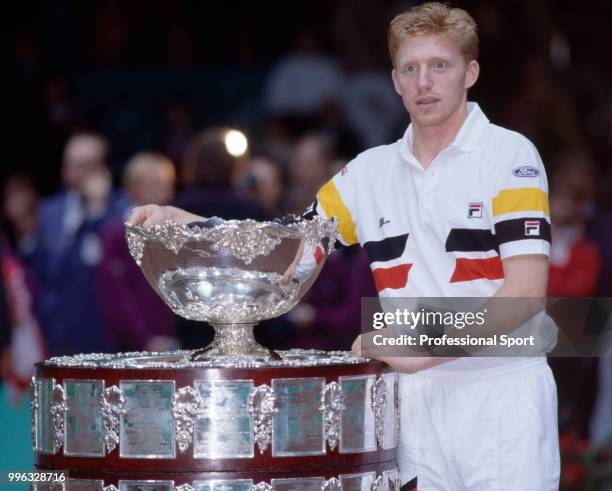 Boris Becker of West Germany poses with the trophy after West Germany defeated Sweden in the Final of the Davis Cup at the Scandinavium arena in...