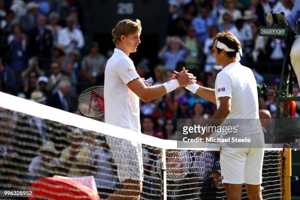 Kevin Anderson of South Africa and Roger Federer of Switzerland embrace at the net following their Men's Singles Quarter-Finals match on day nine of...