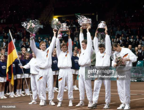 The West German Davis Cup team Boris Becker, Eric Jelen, Patrik Kuhnen, Carl-Uwe Steeb and Niki Pilic lift their trophies after defeating Sweden in...