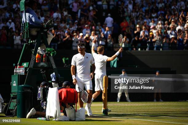 Roger Federer of Switzerland walks to his chair after losing his Men's Singles Quarter-Finals match against Kevin Anderson of South Africa on day...