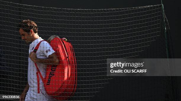 Switzerland's Roger Federer leaves court after losing to South Africa's Kevin Anderson 2-6, 6-7, 7-5, 6-4, 13-11 in their men's singles...