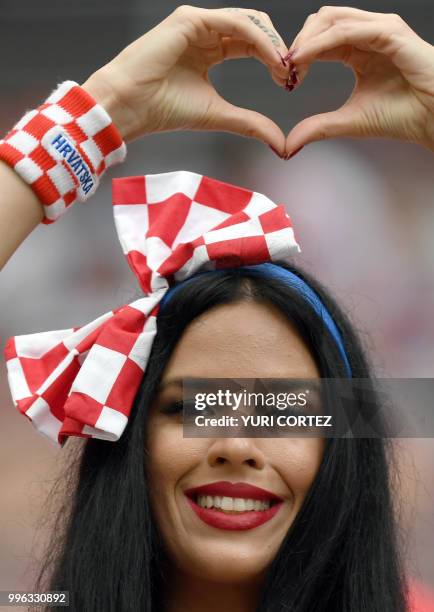 Croatia fan makes a heart shape before the Russia 2018 World Cup semi-final football match between Croatia and England at the Luzhniki Stadium in...