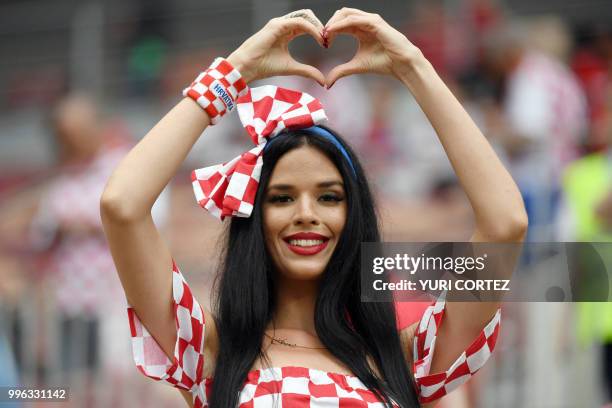 Croatia fan makes a heart shape before the Russia 2018 World Cup semi-final football match between Croatia and England at the Luzhniki Stadium in...