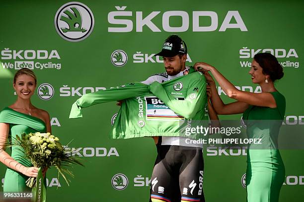 Slovakia's Peter Sagan puts on the best sprinter's green jersey on the podium after winnign the fifth stage of the 105th edition of the Tour de...