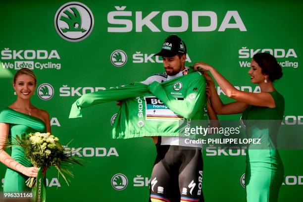 Slovakia's Peter Sagan puts on the best sprinter's green jersey on the podium after winnign the fifth stage of the 105th edition of the Tour de...
