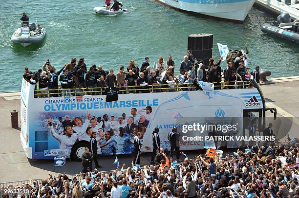 Olympique de Marseille supporters celebrate as the players parade following the team's victory in the French L1 football championship on May 16, 2010...