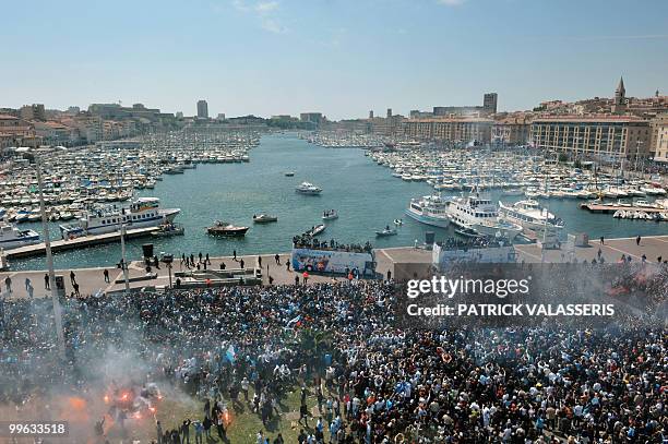 Olympique de Marseille supporters celebrate as the players parade in buses following the team's victory in the French L1 football championship on May...