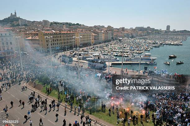 Olympique de Marseille supporters celebrate as the players parade following the team's victory in the French L1 football championship on May 16, 2010...
