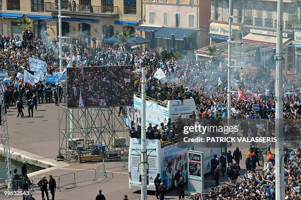 Olympique de Marseille supporters celebrate as the players parade in buses following the team's victory in the French L1 football championship on May...