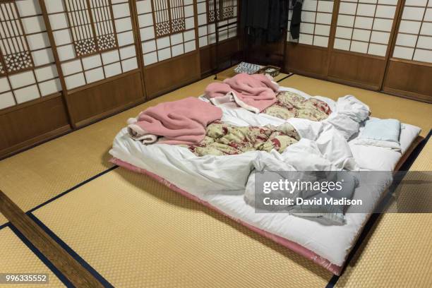 futons and bedding in japanese ryokan - bamboo flooring stock pictures, royalty-free photos & images