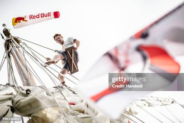 In this handout image provided by Red Bull, Andy Jones of the USA up the mast of the caravel Vera Cruz while sailing on the Tejo River prior to the...