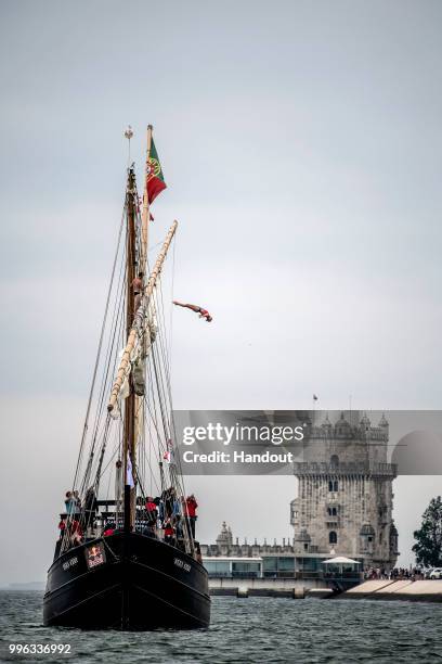 In this handout image provided by Red Bull, Rhiannan Iffland of Australia dives from the mast of the caravel Vera Cruz next to the Belem Tower prior...