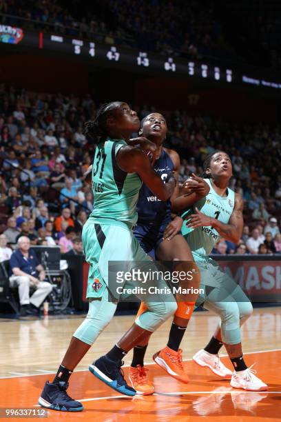 Tina Charles of the New York Liberty and Chiney Ogwumike of the Connecticut Sun battle for position during the game on July 11, 2018 at the Mohegan...